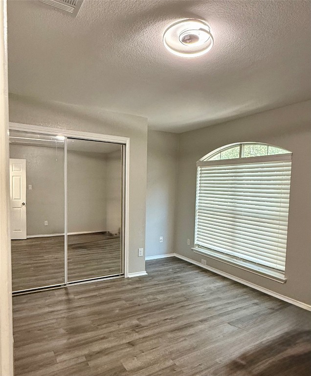 1002 Port Daniel Drive Leander, TX 78641 - Photo 7 of 12 an empty room with wooden floor and windows