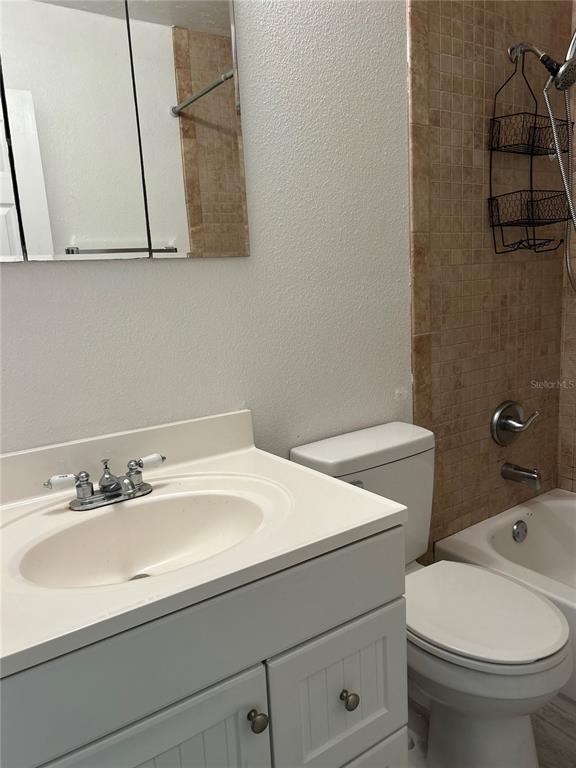 3635 Lalani Boulevard Sarasota, FL 34232 - Photo 11 of 24 a bathroom with a sink a toilet and vanity