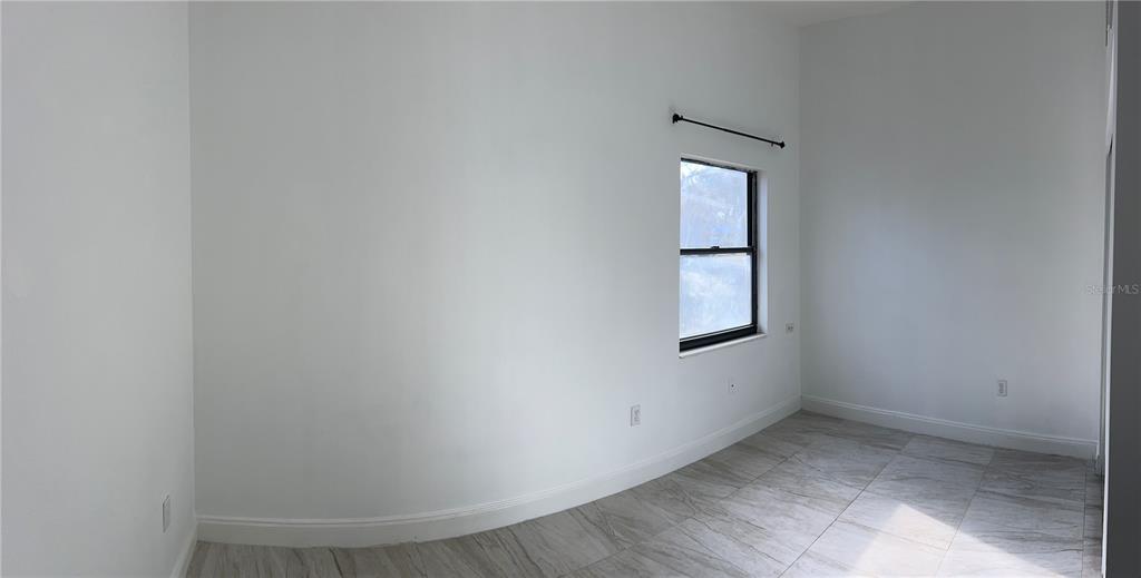 3635 Lalani Boulevard Sarasota, FL 34232 - Photo 18 of 24 a view of an empty room with wooden floor and a window