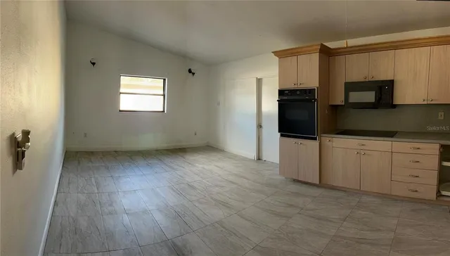 a view of a kitchen with electric appliances