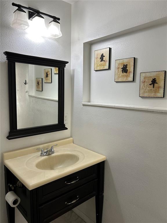 3635 Lalani Boulevard Sarasota, FL 34232 - Photo 23 of 24 a bathroom with a sink and a mirror