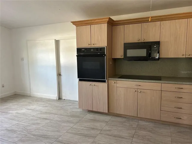 a kitchen with a refrigerator stove and microwave