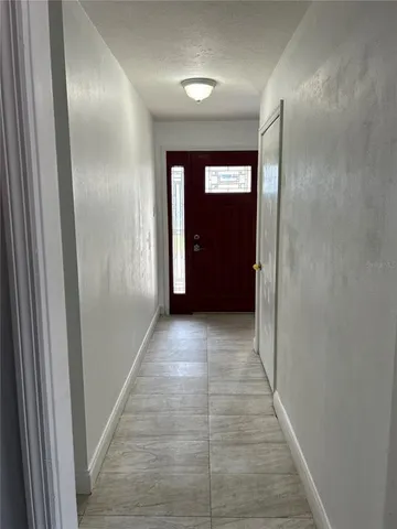 a view of a hallway with wooden shelves