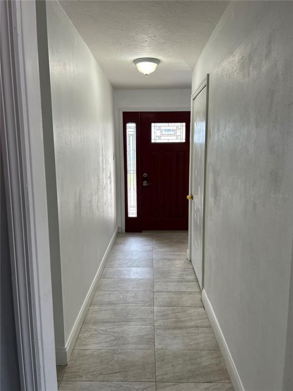 3635 Lalani Boulevard Sarasota, FL 34232 - Photo 7 of 24 a view of a hallway with wooden shelves