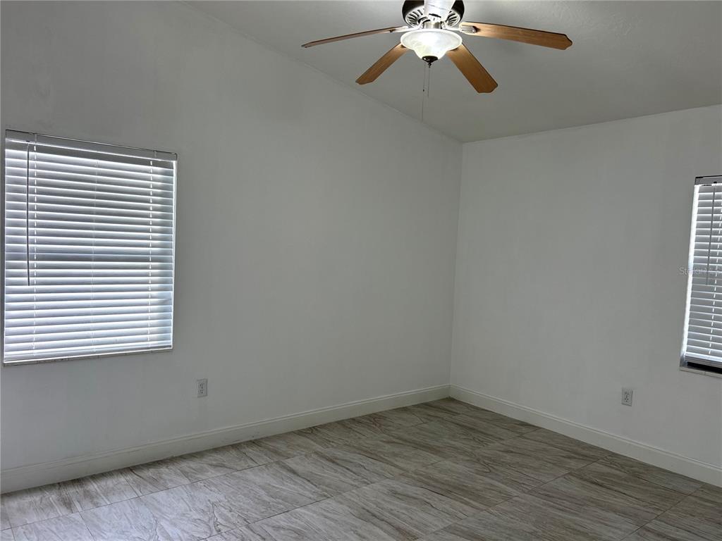3635 Lalani Boulevard Sarasota, FL 34232 - Photo 8 of 24 wooden floor in an empty room with a window
