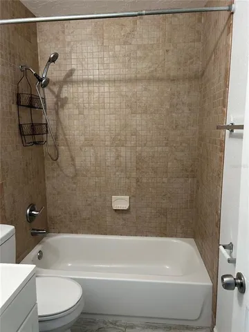 a bathroom with a toilet and a bathtub
