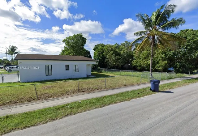 a view of a house with a yard and tree s