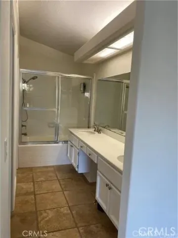 a bathroom with a granite countertop sink a toilet and shower