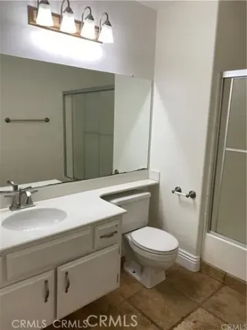 a bathroom with a sink a toilet a mirror and vanity
