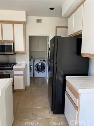 a kitchen with a refrigerator and a stove