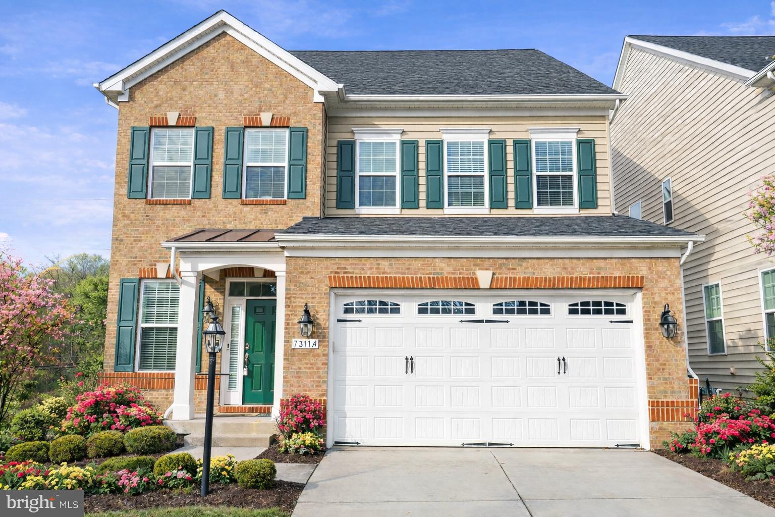 a front view of a house with a yard and outdoor seating