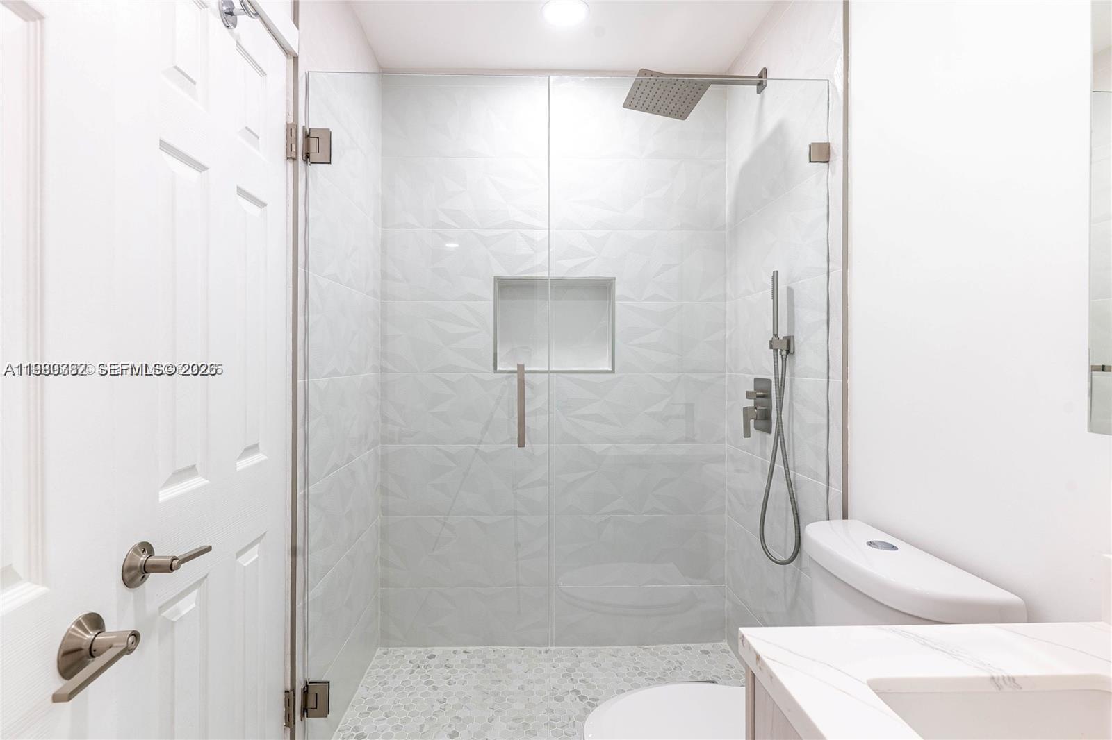 13900 Southwest 65th Terrace, Unit 9 Miami, FL 33183 - Photo 11 of 19 a bathroom with a sink and shower