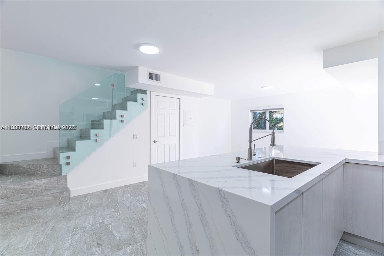 13900 Southwest 65th Terrace, Unit 9 Miami, FL 33183 - Photo 3 of 19 a view of a livingroom with wooden floor and staircase