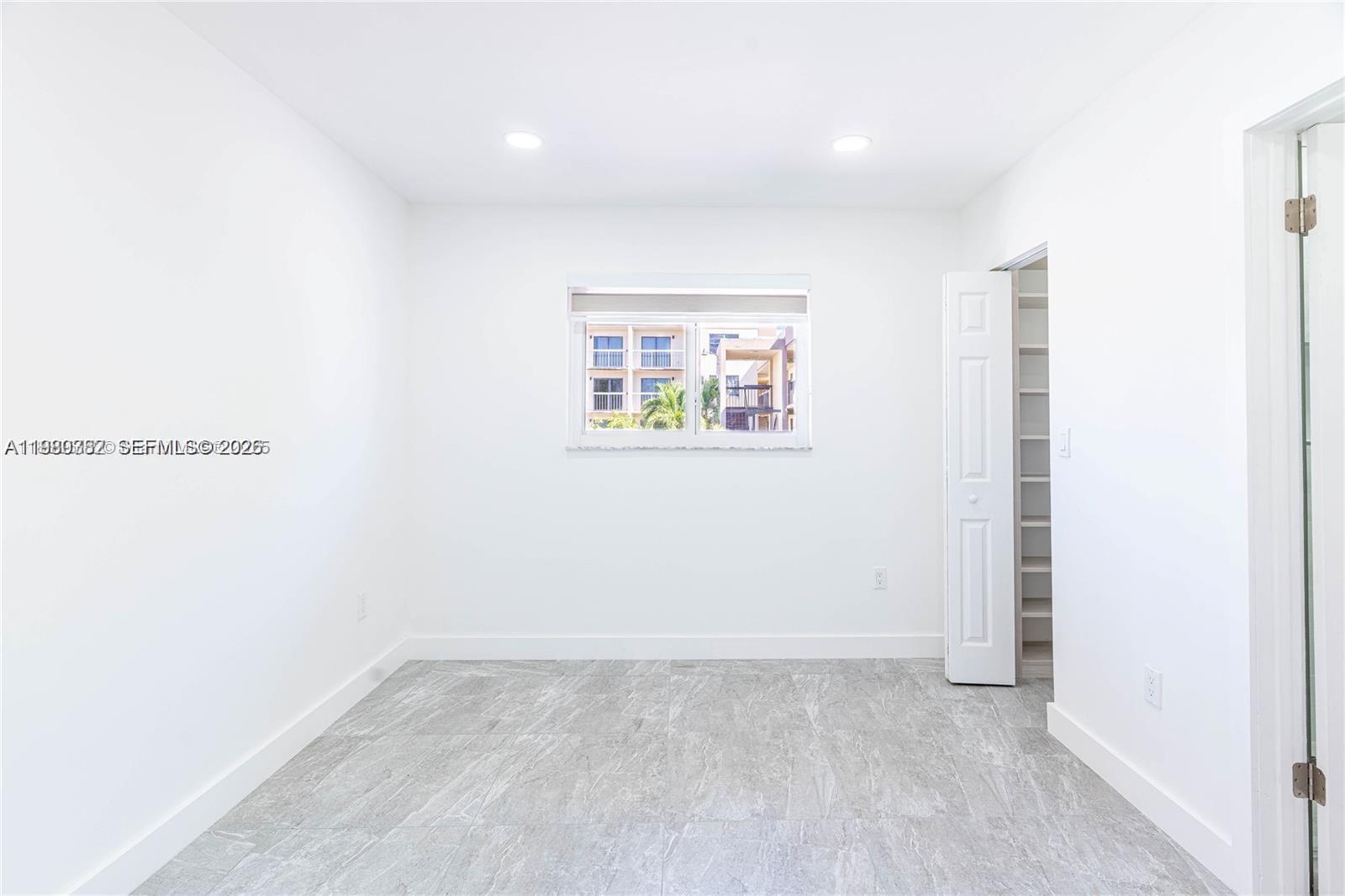 13900 Southwest 65th Terrace, Unit 9 Miami, FL 33183 - Photo 10 of 19 a view of an empty room with a window