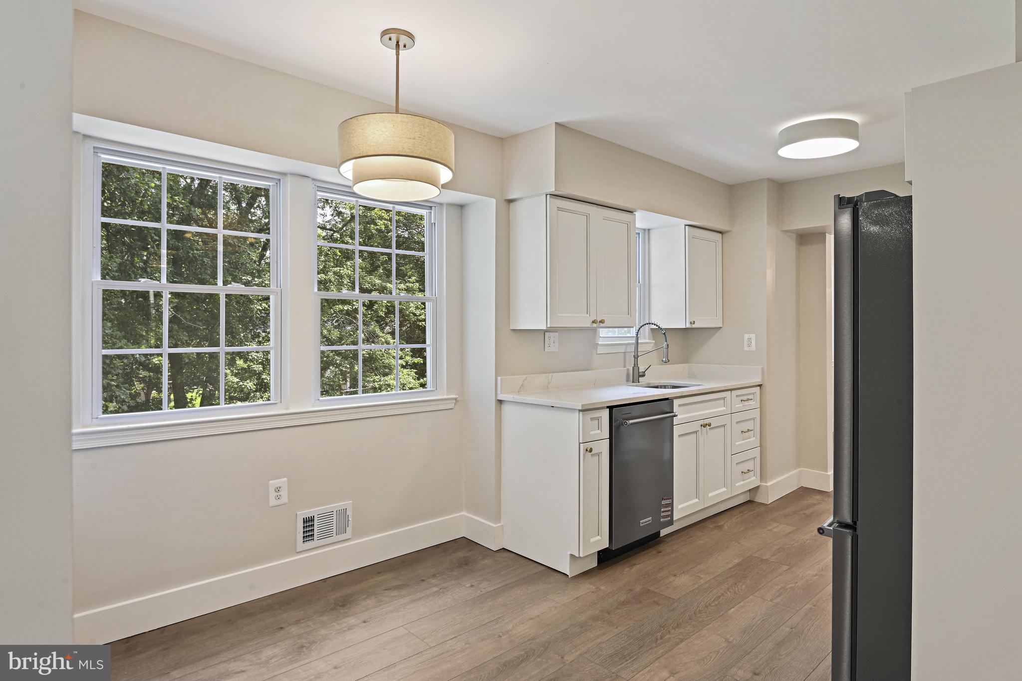 9060 Brook Ford Road Burke, VA 22015 - Photo 12 of 56 a kitchen with a refrigerator and a sink