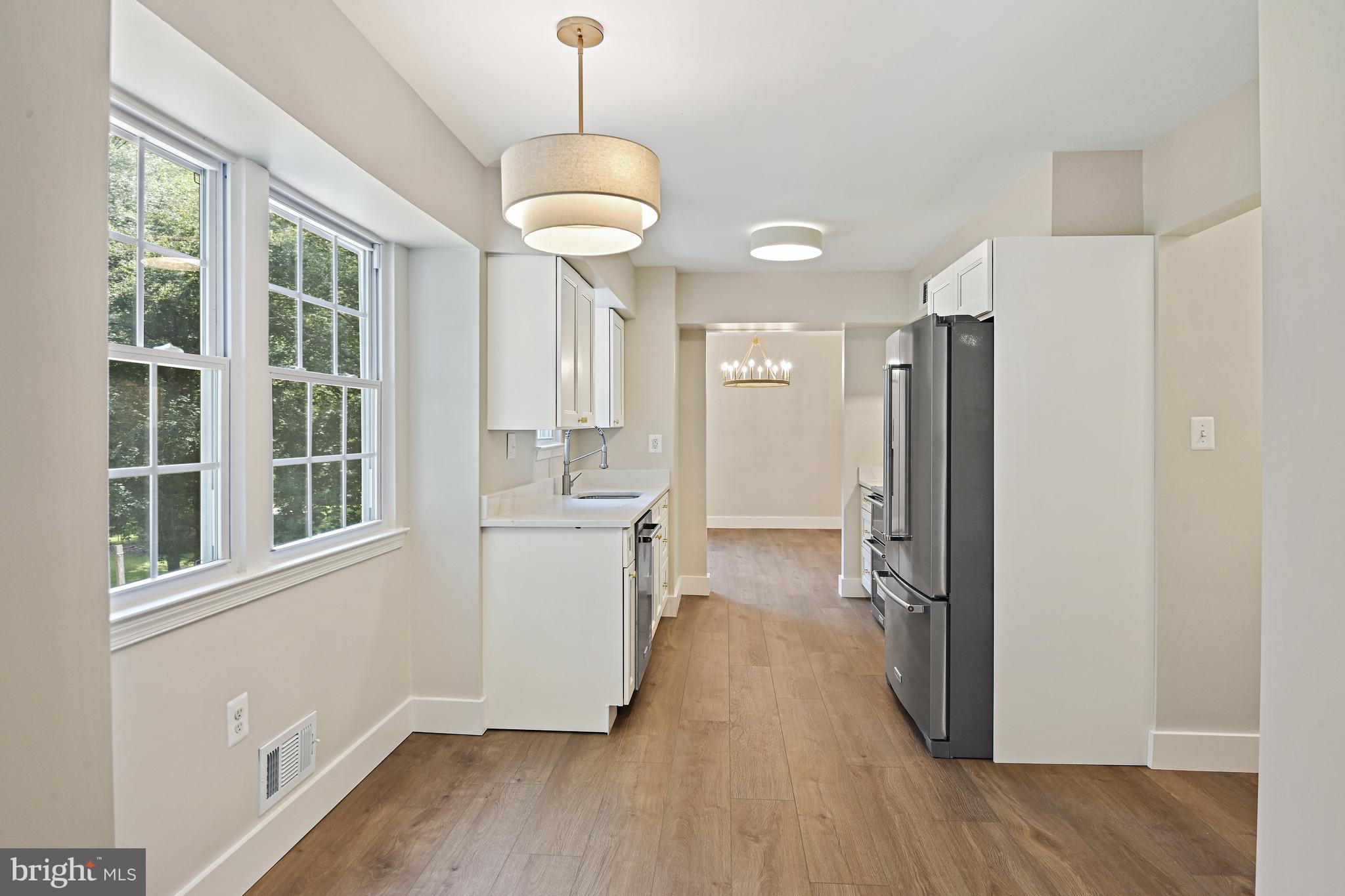 9060 Brook Ford Road Burke, VA 22015 - Photo 13 of 56 a kitchen with a refrigerator a sink and cabinets