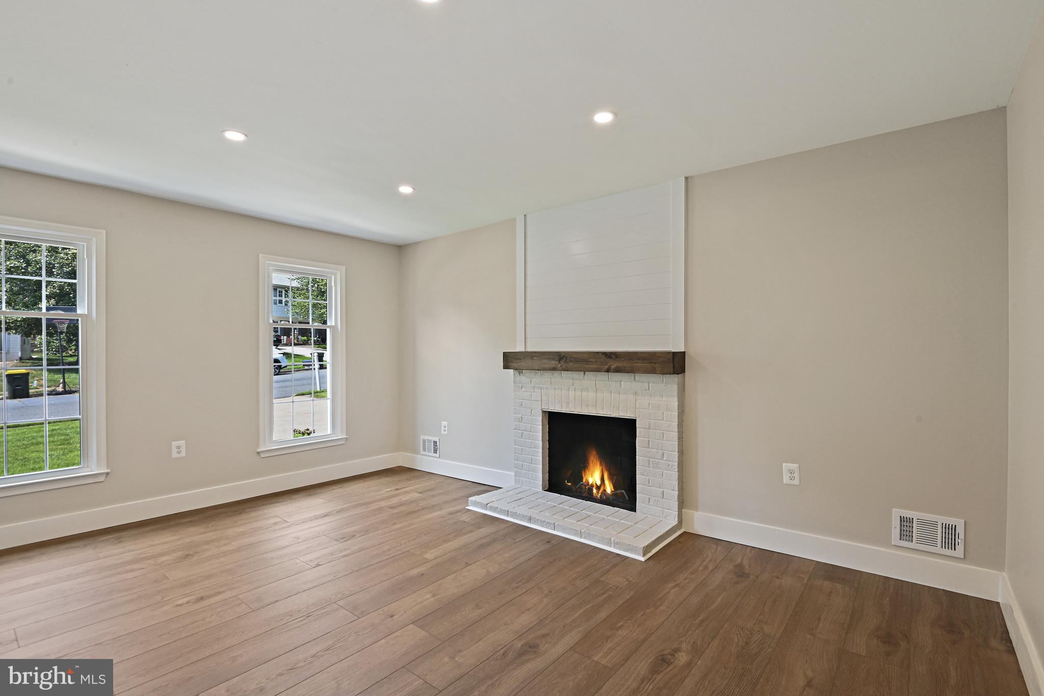 9060 Brook Ford Road Burke, VA 22015 - Photo 15 of 56 a view of an empty room with wooden floor fireplace and a window