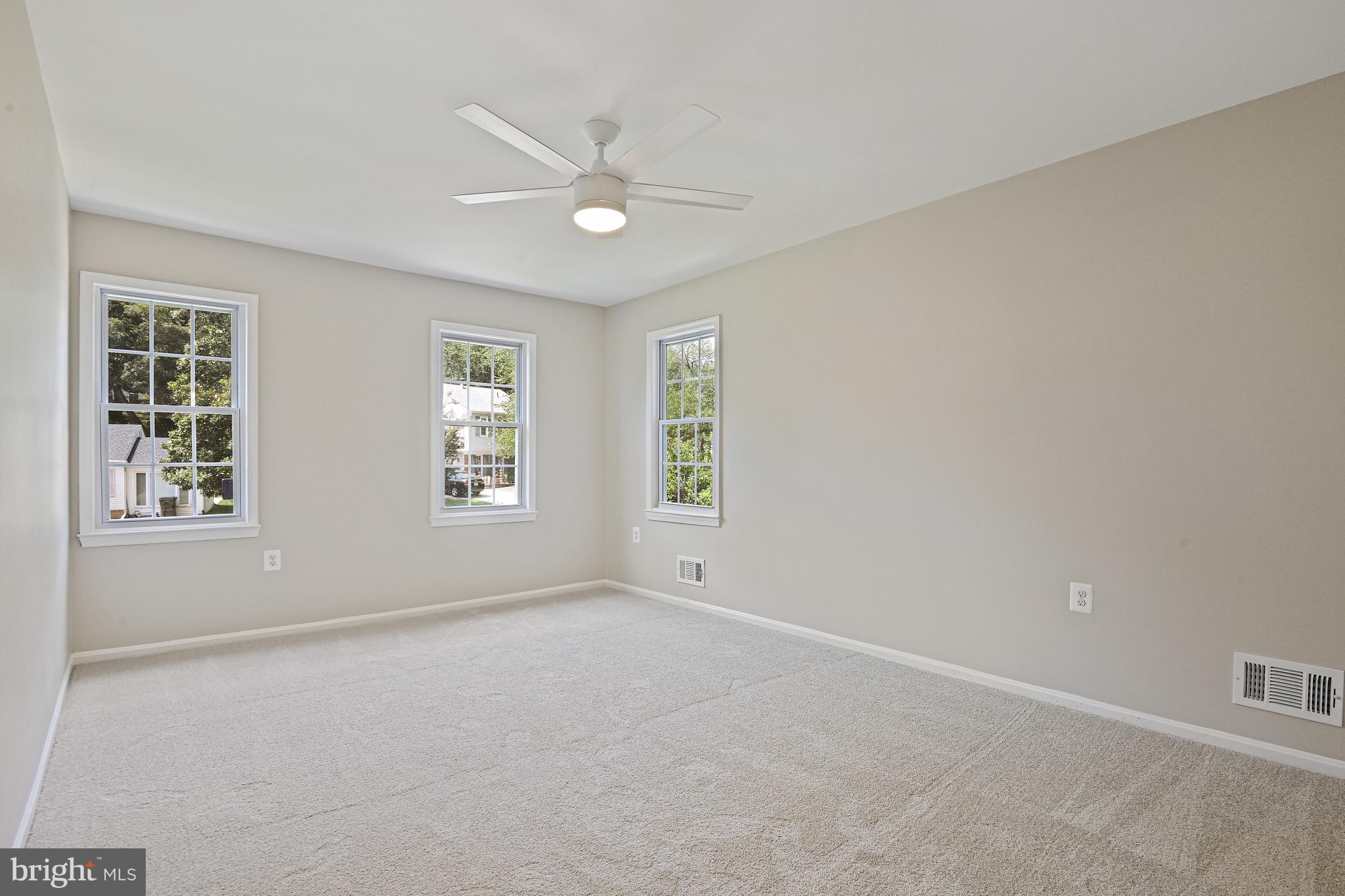 9060 Brook Ford Road Burke, VA 22015 - Photo 22 of 56 an empty room with windows and fan