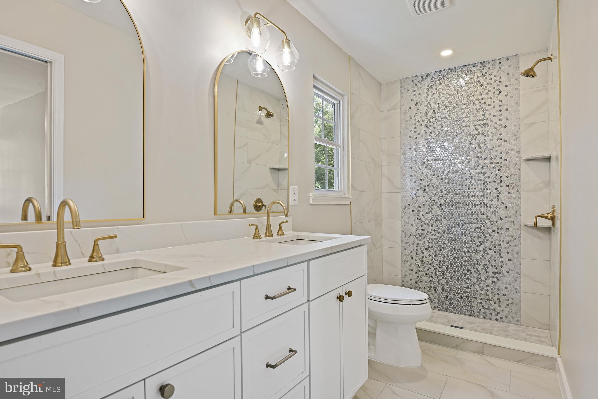 9060 Brook Ford Road Burke, VA 22015 - Photo 26 of 56 a bathroom with a granite countertop sink a toilet and a mirror