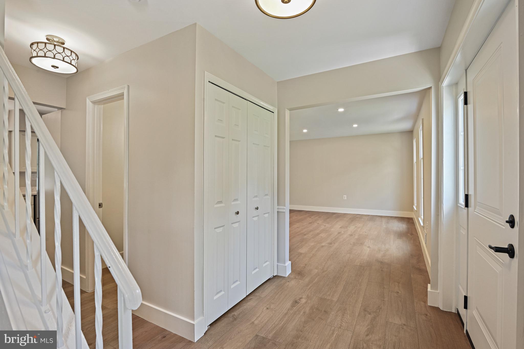 9060 Brook Ford Road Burke, VA 22015 - Photo 3 of 56 a view of a hallway with wooden floor and stairs