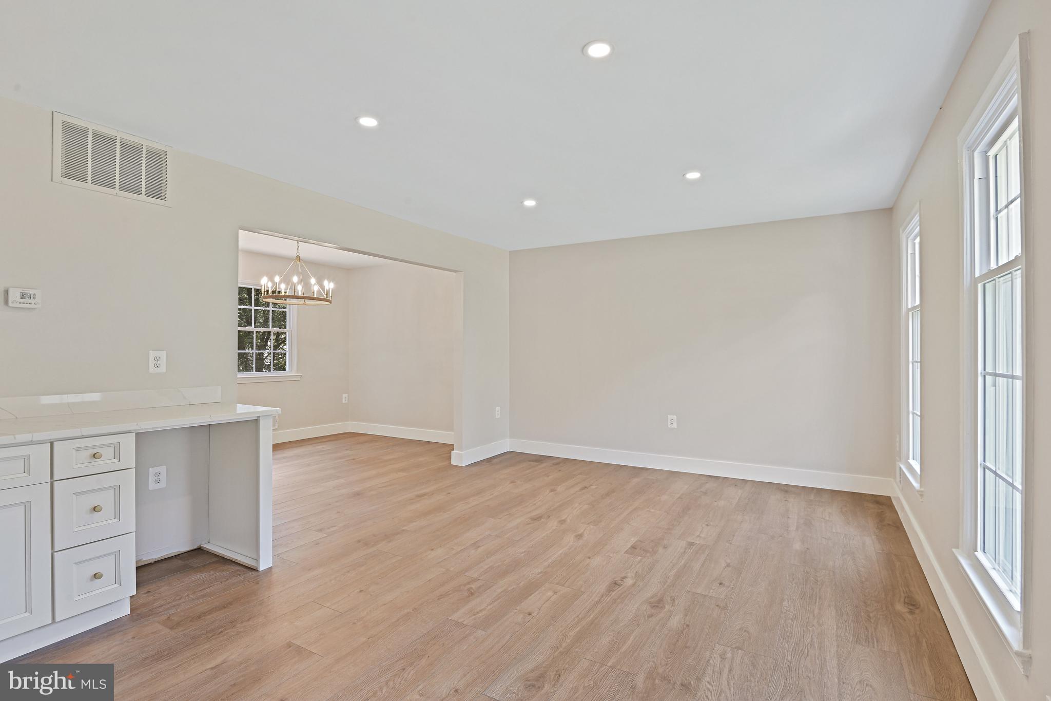 9060 Brook Ford Road Burke, VA 22015 - Photo 5 of 56 an empty room with wooden floor and windows