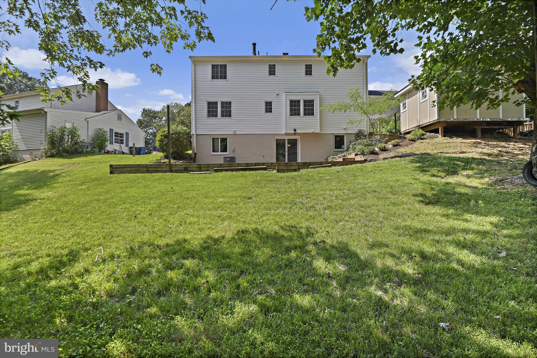 9060 Brook Ford Road Burke, VA 22015 - Photo 51 of 56 a view of a house with a back yard