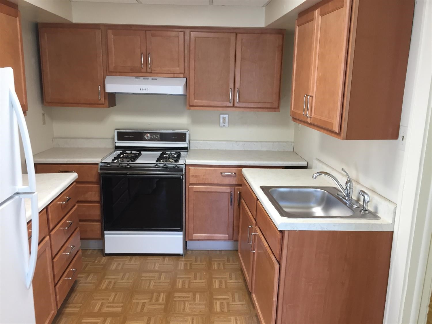 133-39 West Ridge Road Gary, IN 46408 - Photo 20 of 25 a kitchen with a sink stove and cabinets