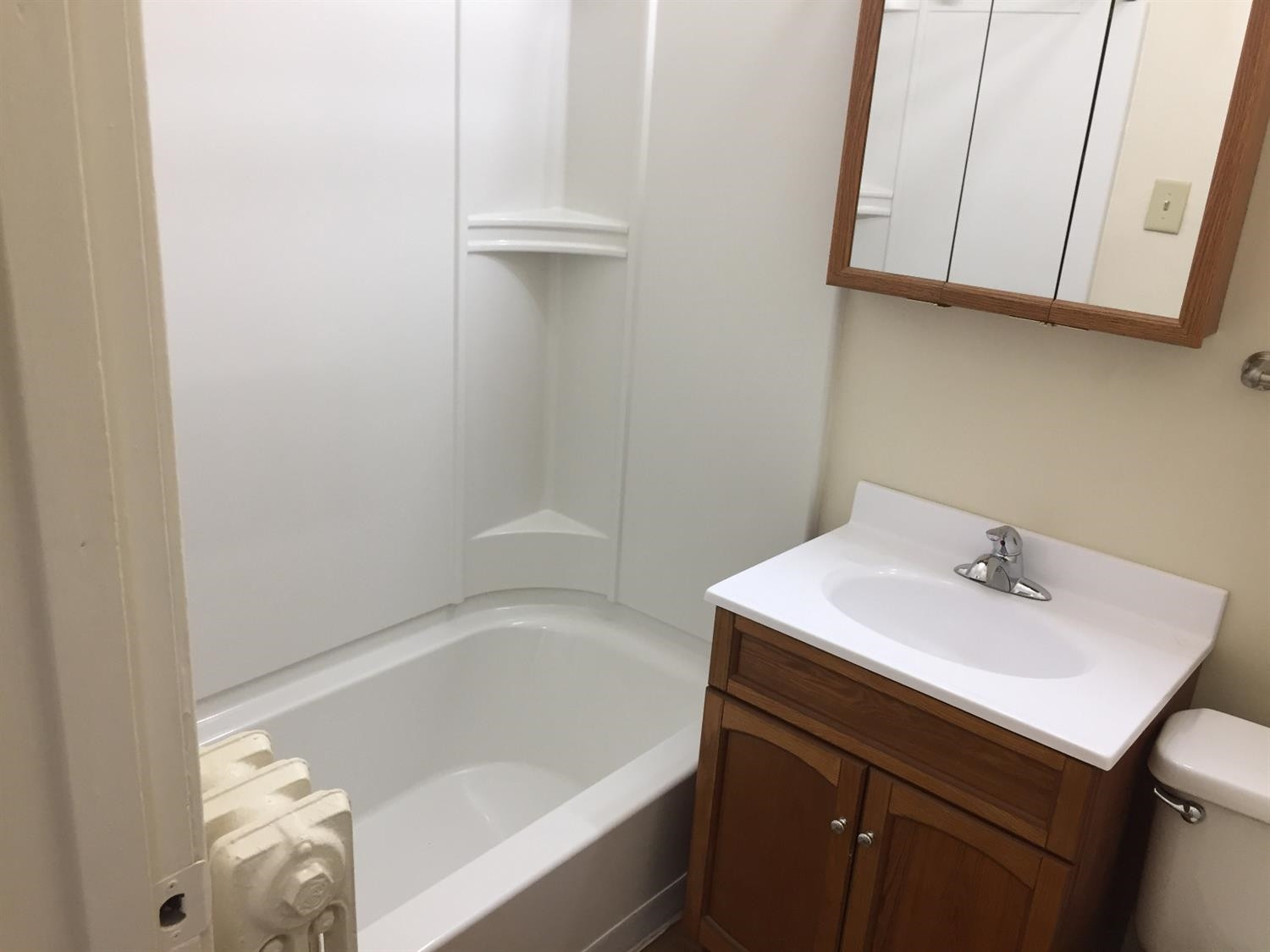 133-39 West Ridge Road Gary, IN 46408 - Photo 22 of 25 a bathroom with a sink a vanity and bathtub