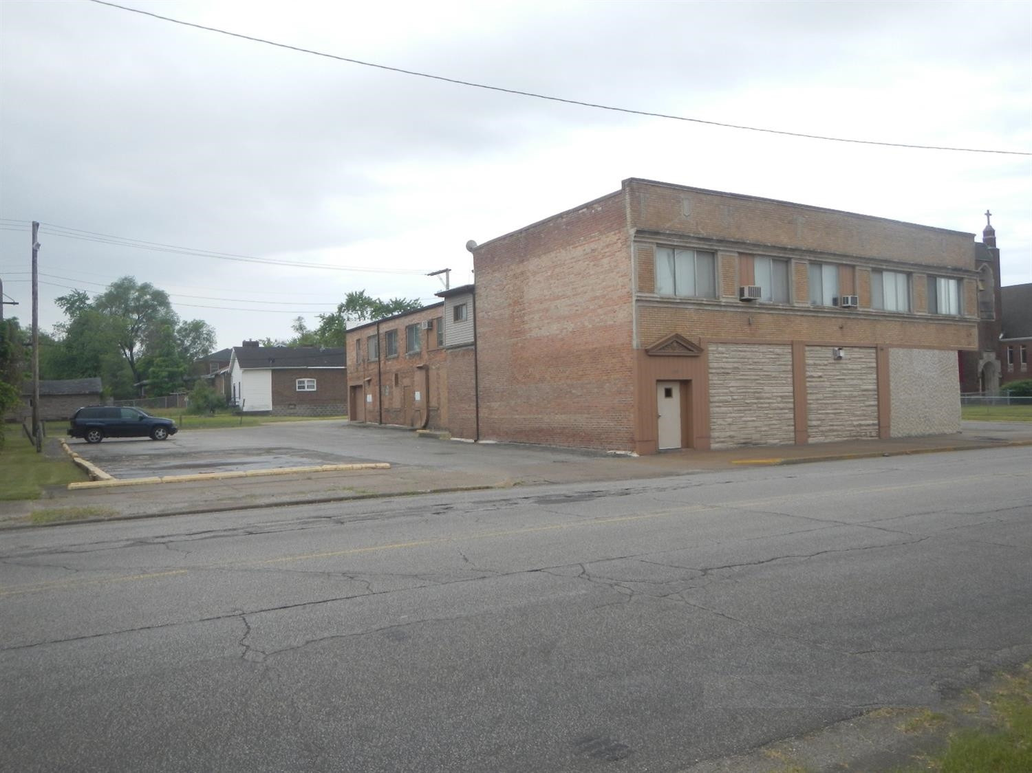 133-39 West Ridge Road Gary, IN 46408 - Photo 3 of 25 a tall building with a bench in front of it