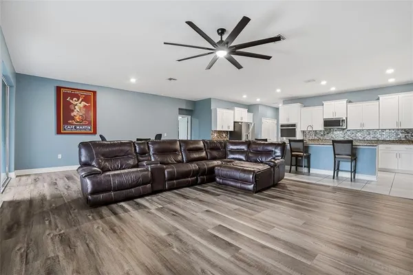 a kitchen with kitchen island granite countertop wooden cabinets and stainless steel appliances