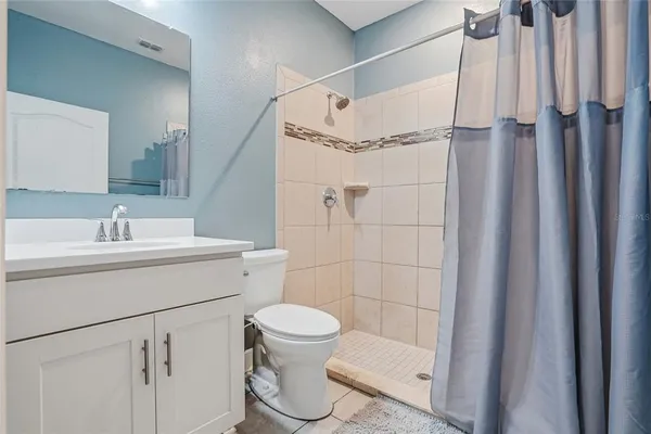 a bathroom with a double vanity sink toilet and mirror