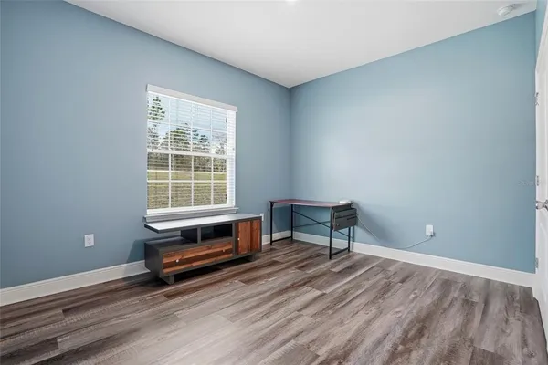 a spacious bathroom with a granite countertop sink a toilet and a mirror