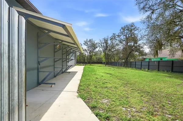 a front view of a house with a garden and yard