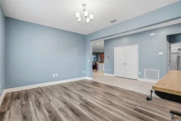 a dining room with furniture and wooden floor