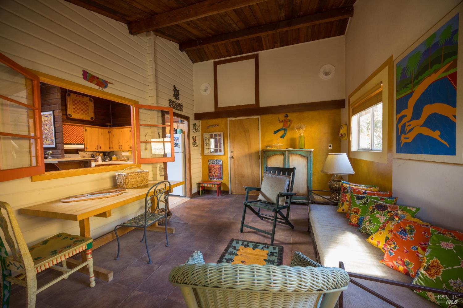28678 River Road Cloverdale, CA 95425 - Photo 21 of 36 a living room with furniture a dining table and chairs with wooden floor