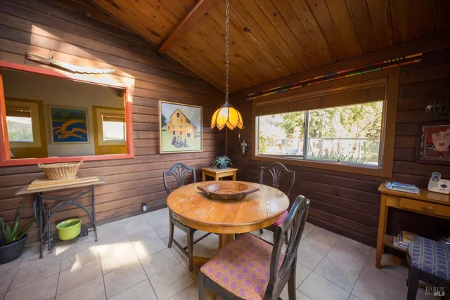 a view of a dining room with furniture and window
