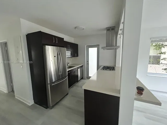 a kitchen with stainless steel appliances a refrigerator and a sink