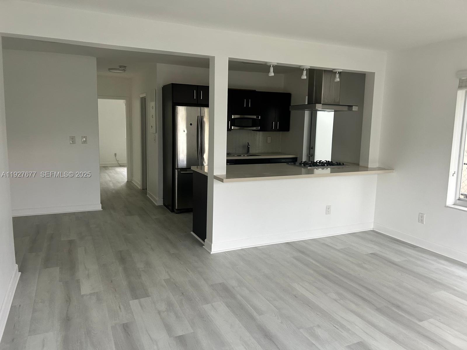 7430 Carlyle Avenue, Unit 2 Miami Beach, FL 33141 - Photo 2 of 8 wooden floor in a kitchen