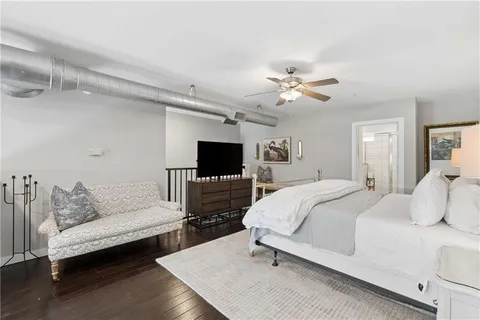 a spacious bedroom with a bed and a couch