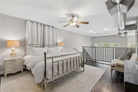 a bedroom with bed and wooden floor