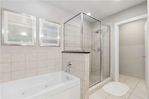 a bathroom with a bathtub and a shower