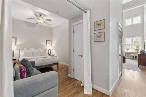 a living room with furniture and wooden floor