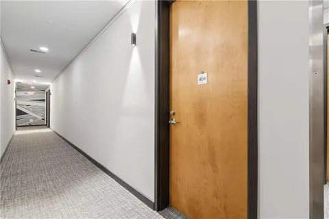 a view of a hallway with a bathroom
