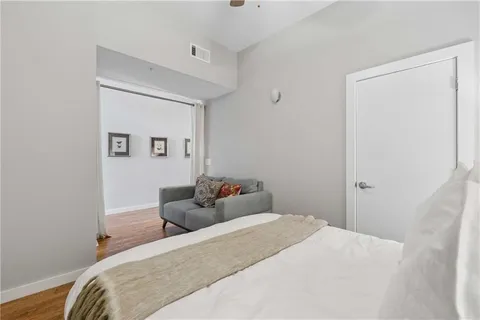 a bedroom with a bed and hallway