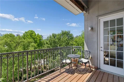 a view of a balcony with table and chairs and wooden floor