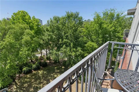 a balcony with wooden floor and fence