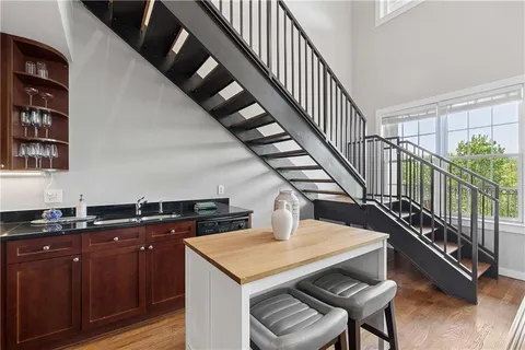 a kitchen with wooden cabinets a sink and white appliances