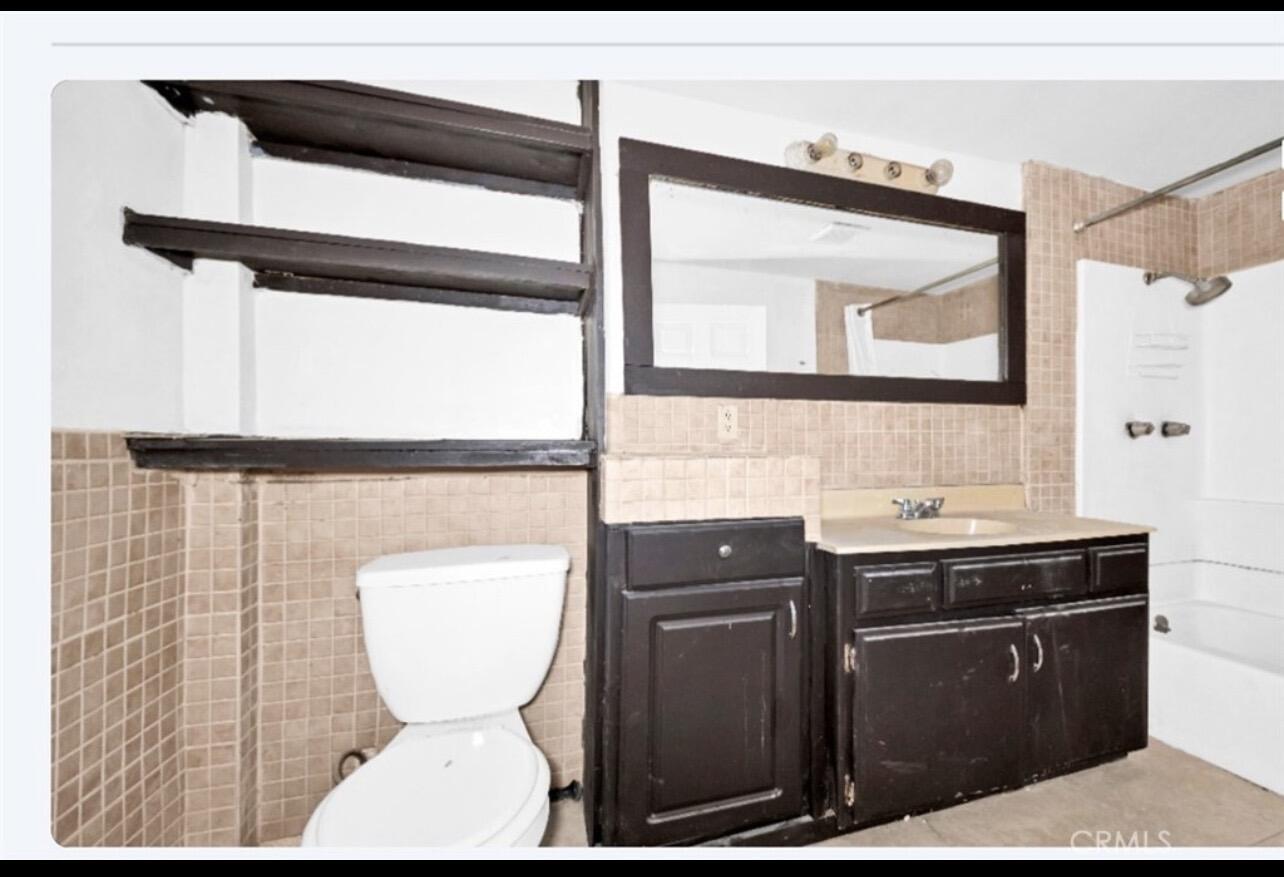 82481 Valencia Avenue Indio, CA 92201 - Photo 8 of 13 a bathroom with a toilet a sink and mirror