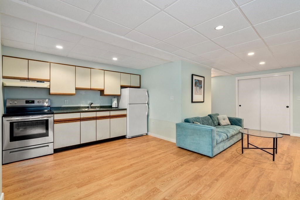 40 Kingswood Road Newton, MA 02466 - Photo 23 of 30 a kitchen with stainless steel appliances granite countertop a stove a sink and a refrigerator