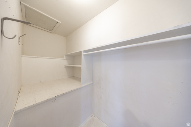 193 Locust Street Clearfield, UT 84015 - Photo 7 of 29 Interior storage space featuring built-in shelving, a hanging rod, and wall-mounted hooks